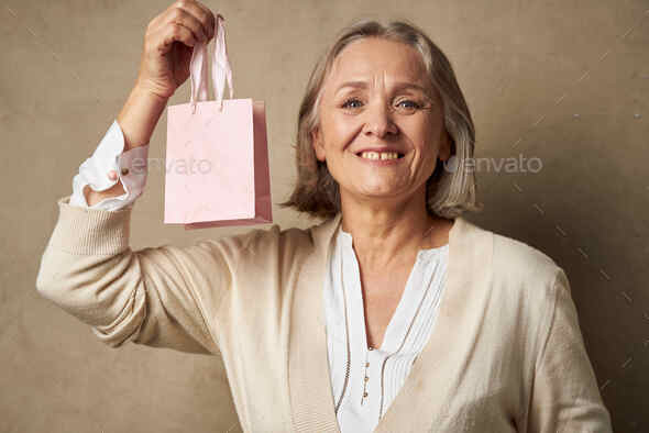 Elderly woman with gifts, Stock image