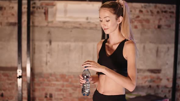 Exhausted Athletic Woman Taking Break In Gym alt