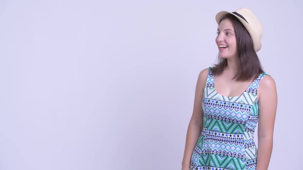 Happy Young Beautiful Tourist Woman Touching Something and Looking Surprised alt