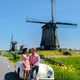 couple doing a road trip with a old vintage car in the Dutch flower bulb region with tulip fields - PhotoDune Item for Sale
