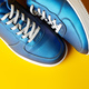 Blue new sneakers on yellow studio background - PhotoDune Item for Sale