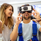 Couple enjoying with VR goggles at tech store. Shopping couple having fun at marketplace. - PhotoDune Item for Sale