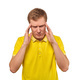 Stressed young man in yellow T-shirt with migraine headache isolated on white background - PhotoDune Item for Sale