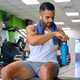 Strong Latin man opening his water bottle at a gym. - PhotoDune Item for Sale