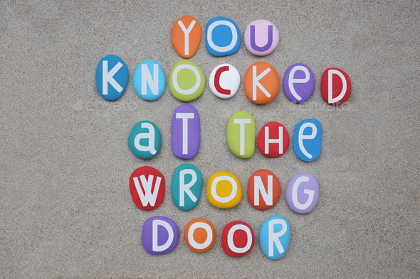 You knocked at the wrong door, creative text composed with multi colored stone letters