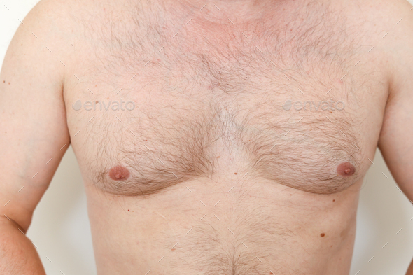 Close up of hairy man\'s chest, male nipples, light thin hair on breast unrecognisable young guy.