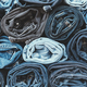 Lots of rolled up jeans. Denim background. Trendy denim clothing, shopping, fashion, consumption. - PhotoDune Item for Sale