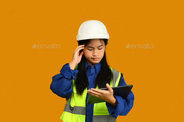 Asian girl holding helmet isolated on yellow background, future dream job career.