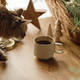Cute tabby cat smelling stylish cup of warm tea on table with fir branches in basket, wooden trees - PhotoDune Item for Sale