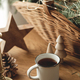 Stylish cup of warm tea, fir branches in basket, wooden trees and star, pine cones and lights - PhotoDune Item for Sale