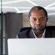 Serious thinking boss businessman close up, african american man working with laptop, man reading - PhotoDune Item for Sale