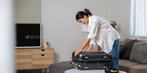 Portrait of beauty asian traveler woman pack prepare stuff and outfit clothes in suitcase travel - Stock Photo - Images
