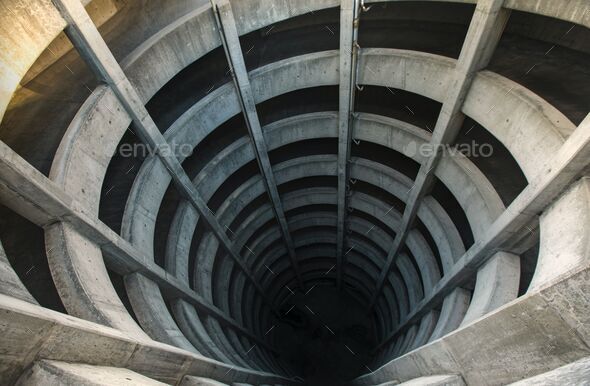 Aerial view of a spiral tunnel extending into an illusion of a deep and dark rabbit hole