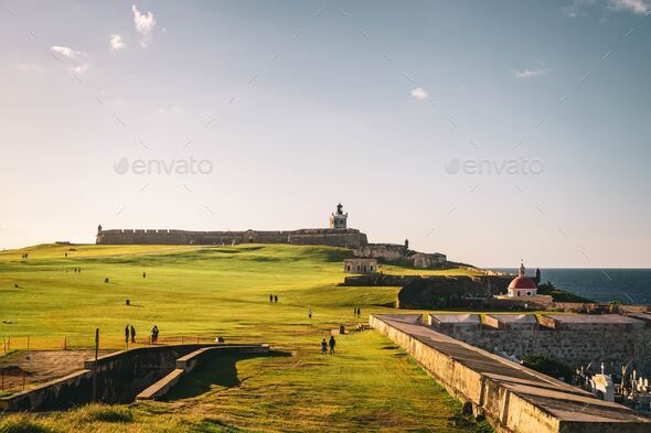 Landscape view of El Morro with visitors in sunlight, San Juan, Puerto Rico - Stock Photo - Images