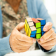 Alzheimer disease AD, Asian elderly woman patient playing Rubik cube game to practice brain training - PhotoDune Item for Sale