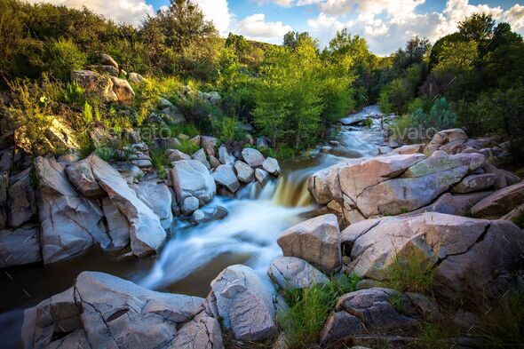 Scenic long exposure of Lynx Creek flows through a beautiful stone path in Prescott Valley