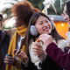 Happy smiling multiracial friends eating chocolate with churros together outdoors. Winter festival. - PhotoDune Item for Sale