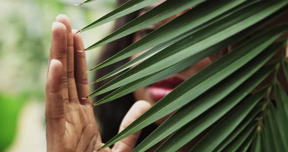 Beautiful Girl African American with Tanned Skin Poses and Walks Among Tropical alt