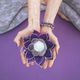 Top angle view of hands holding a purple glass lotus.  Yoga and meditation concept. - PhotoDune Item for Sale