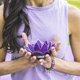 Close up of woman&#39;s hands holding a purple glass lotus. Yoga and meditation concept. - PhotoDune Item for Sale
