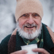 Portrait of elegant senior man drinking hot tea outdoors, during cold winter snowy day. - PhotoDune Item for Sale