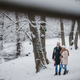 Elegant senior couple walking in the snowy park near the river, during winter snowy day. - PhotoDune Item for Sale