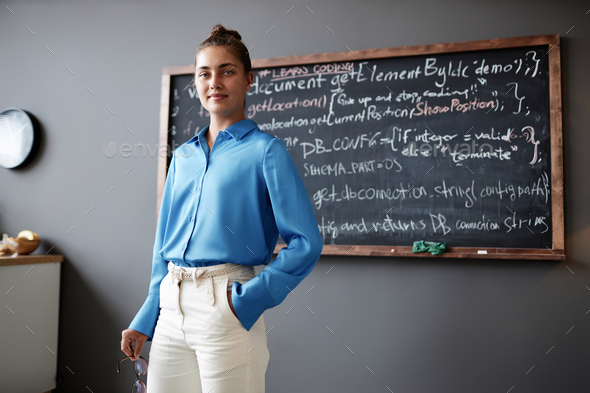 Young IT teacher standing in the classroom
