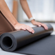 Woman roll her yoga mat after class - PhotoDune Item for Sale