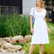 Young woman in white dress waiting for taxi in townhouse - PhotoDune Item for Sale
