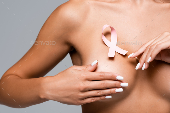 Closeup cropped portrait young woman with breast pain touching chest  colored isolated on background - Your Health