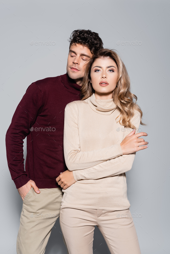 Playful Young Couple posing in studio. Isolated neutral background.  Royalty-Free Stock Image - Storyblocks