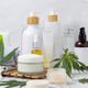 Blank cosmetic jars, tubes and bottles near green cannabis leaves close up, CBD cosmetic mockup - PhotoDune Item for Sale