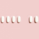 Mix of medical pills with one empty place in a line on light pink top view. Dietary supplements - PhotoDune Item for Sale
