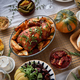 Close up of delicious turkey dish with roasted potatoes on elegant dinner table - PhotoDune Item for Sale