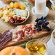 Close up of charcuterie board with meats and cheeses on festive dinner table for - PhotoDune Item for Sale