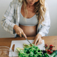 Beautiful young pregnant woman chop vegetables to prepare a salad. - PhotoDune Item for Sale
