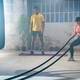 Fitness athletes training using battle ropes intense workout exercise in gym friends enjoying. - PhotoDune Item for Sale