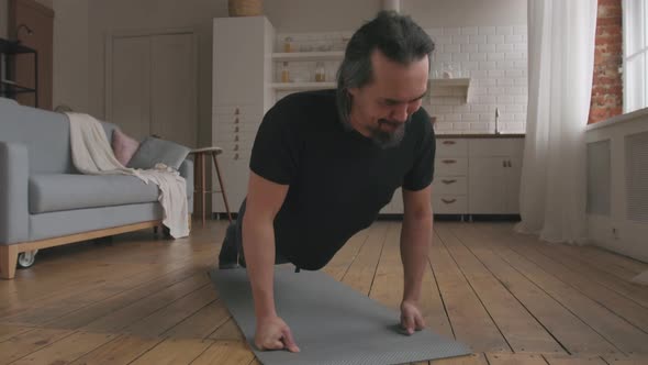 Middle Aged Man Doing Push-ups at Home alt
