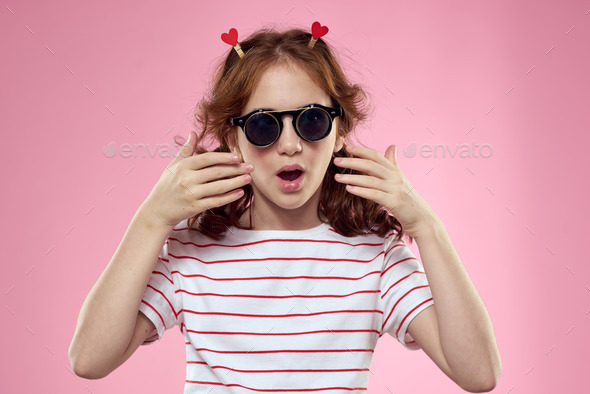 Girl With Glasses On Her Face Clothespins On Her Hair Pink Background