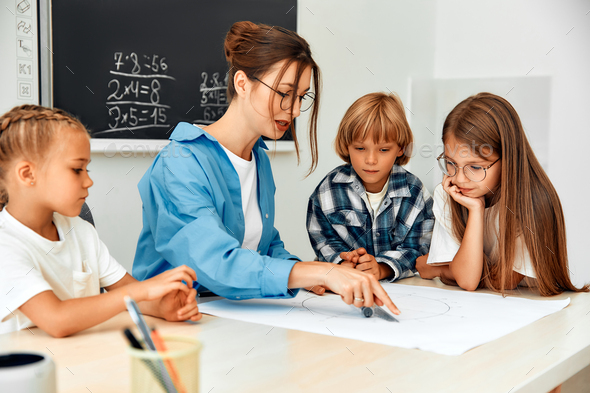 Children learning in a school classroom Stock Photo by ORION_production