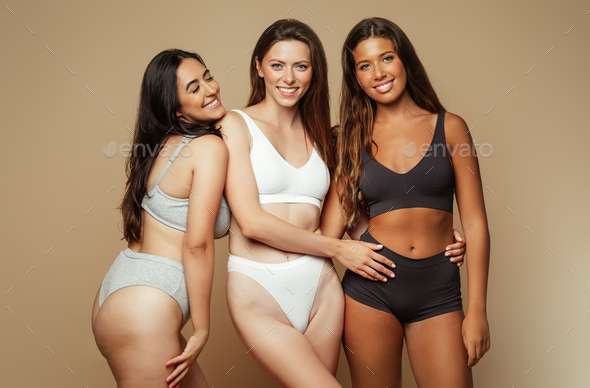 Glad millennial diverse women in underwear with different body