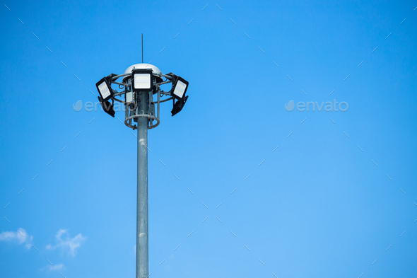High power LED outdoor for street lamp post flood light pole on clear blue sky copy space.