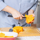 Senior Caucasian woman peeling pumpkin in home cuisine - PhotoDune Item for Sale