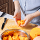Senior Caucasian woman holding chopped pieces of ripe pumpkin in her hands - PhotoDune Item for Sale