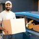 Middle Eastern Deliveryman Holds Cardboard Box Near His Modern Automobile - PhotoDune Item for Sale