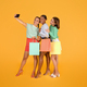 Cute stylish multiracial girlfriends taking selfie while shopping - PhotoDune Item for Sale