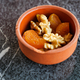 walnut and dried peach fruit on in a small bowl on tiles background  - PhotoDune Item for Sale
