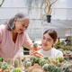 Seniors women with her daugther holding potted cactus at plant market. - PhotoDune Item for Sale