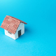 Miniature house on a blue background.  - PhotoDune Item for Sale