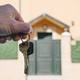 hands holding keys with a house in the background - PhotoDune Item for Sale
